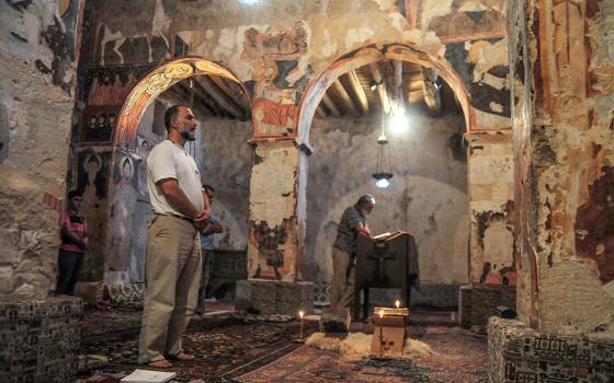 Syriac Catholic Fr. Jihad Youssef prays inside the church of Mar Musa Monastery in Syria in June 2017. Youssef became head of the monastic community in 2021. (Newscom/picture-alliance/dpa/Simon Kremer)