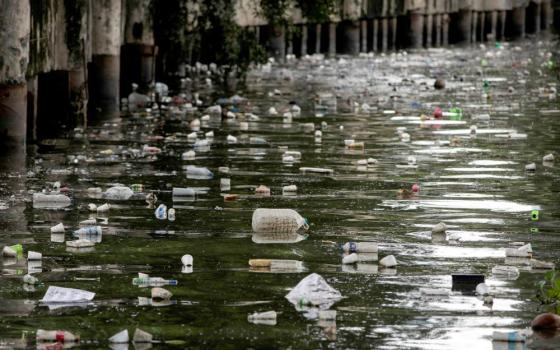 Plastic bottles float on the heavily polluted San Juan River, a tributary of Pasig River in Mandaluyong City, Philippines, June 21, 2021. (CNS photo/Eloisa Lopez, Reuters)