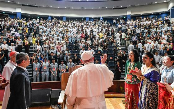 Pope Francis waves to young people gathered for a meeting on interreligious dialogue at the Catholic Junior College in Singapore Sept. 13. (CNS/Vatican Media)