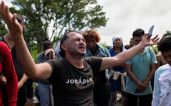 A migrant prays Aug. 22 in Sayula de Aleman, Mexico, along with others during a pause on their journey toward the U.S. border. (OSV News/Reuters/Angel Hernandez)