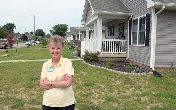 Benedictine Sr. Jane Michele McClure poses outside a new Habitat for Humanity of Evansville house at St. Theresa Place. McClure, major gifts officer at Habitat, suggested the organization work with members of a closed parish to build homes on the former church's site. (Courtesy of Habitat for Humanity of Evansville, Indiana)