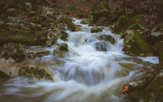 Water flows through rocks.