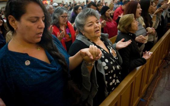 Worshippers recite the Lord's Prayer during a Mass celebrated in honor of the 100th anniversary of Our Lady of Guadalupe Church in San Diego, Dec. 9, 2017. (OSV News photo/David Maung)