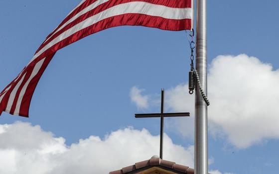 An American flag frames a cross atop Immaculate Conception Catholic Church in Cottonwood, Ariz., Oct. 29. The parish hall of the church is a polling station for voters in the Nov. 5 election. Arizona is one of seven battleground states this year. (OSV News/Bob Roller)