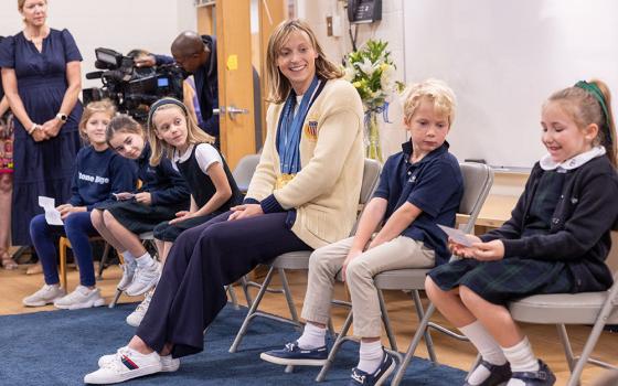 Olympic swimming champion Katie Ledecky visits her alma mater, Stone Ridge School of the Sacred Heart in Bethesda, Md., on Oct. 22 and listens as second grader Anna Reilly at right asks her a question. The other students from left to right are fourth grader Annie Siciliano, third grader Lilly Bracewell, first grader Amelia Farrell and kindergartener Bowen Wiegmann. (OSV News/Catholic Standard/Mihoko Owada)