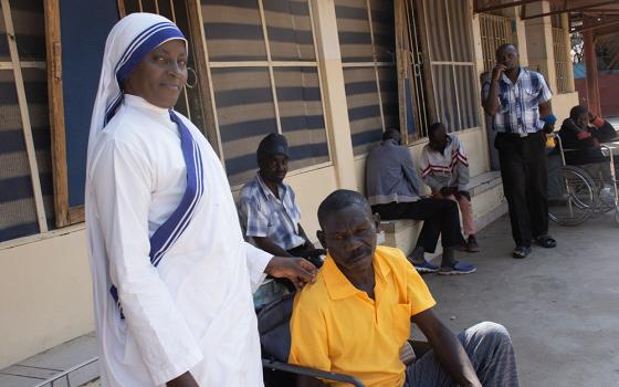 Sr. Mercy Kanyoro interacts with patients at the Mother Theresa Hospice. The hospice is a refuge for the sick and dying, located on the outskirts of Kabulonga, an exclusive suburb adjacent to Kalingalinga, a slum in Lusaka, Zambia. (Derrick Silimina)