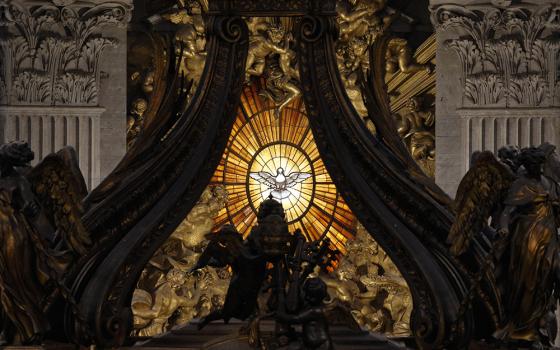 The Holy Spirit window is pictured through the Baldacchino in St. Peter's Basilica at the Vatican. (CNS/Paul Haring)