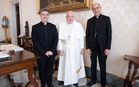 Pope Francis poses for a photo with Msgr. Armando Matteo, left, secretary of the doctrinal section of the Dicastery for the Doctrine of the Faith, and Cardinal Víctor Manuel Fernández, dicastery prefect, during a meeting in the library of the Apostolic Palace at the Vatican, on Dec. 18, 2023, the date Fiducia Supplicans was released for publication. (CNS/Vatican Media)