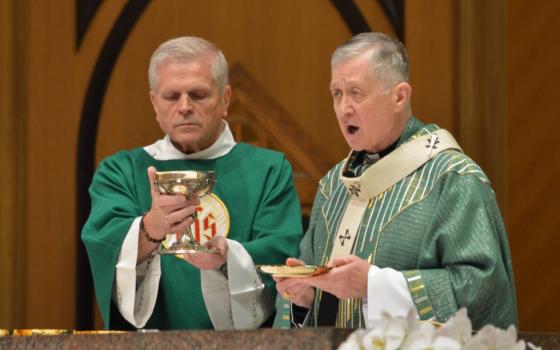 Chicago Cardinal Blase J. Cupich, right, celebrates Mass at Holy Name Cathedral in Chicago June 30, 2024. Cupich is calling for faithful to receive holy Communion standing -- the normative posture established by the U.S. Catholic bishops -- as part of a renewed awareness of the theology of the Communion procession, which symbolizes the unity of the body of Christ as it partakes of the central mystery of the Catholic faith. (OSV News photo/Simone Orendain)