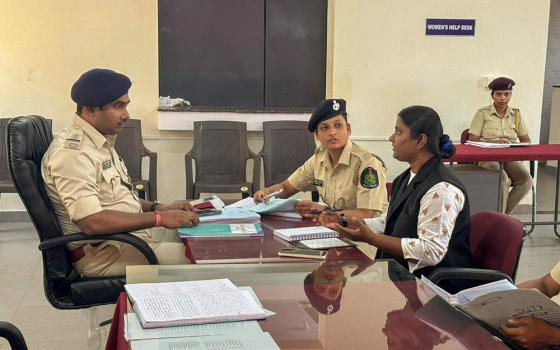 Canossian Sr. Grasy Rodrigues discusses a rape case with police personnel at Mandarem, Goa, western India. (Courtesy of Grasy Rodrigues)