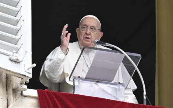 Francis at window, hand raised in blessing.