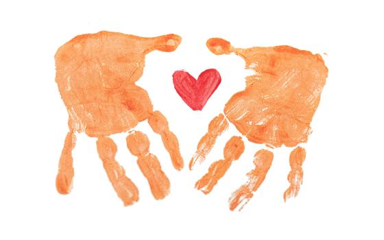 Two painted hands surrounding a heart (Unsplash/Rod Long)