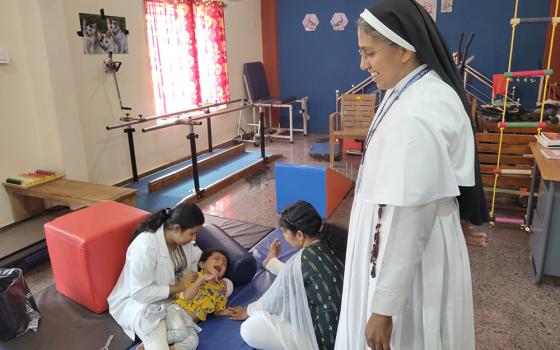 Sr. Mareena Mathew, a Franciscan Clarist nun, is pictured with a therapist and Keerthi Ramakrishnan, discussing physiotherapy at Navajeevana Endosulfan Special School, Bedrampalla, Kasaragod District, Kerala, southwestern India. Ramakrishnan's son attends the school. (George Kommattam)