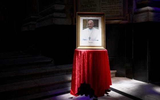 A portrait of Pope Francis is displayed at the Basilica San Jose de Flores in Buenos Aires, Argentina, Feb. 21, 2025, where Pope Francis, then Cardinal Jorge Bergoglio, once served. The 88-year-old pontiff was in critical condition Feb. 22 after he suffered a prolonged asthmatic respiratory crisis while being treated for pneumonia and a complex lung infection, the Vatican said. (OSV News photo/Tomas Cuesta, Reuters)