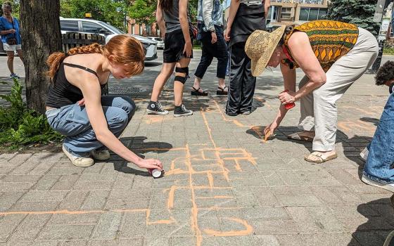 Talitha Kum ambassadors in Montreal take part in the activity "Agissons enSable," using colourful sand as a symbol of the vulnerable population at risk of falling between the cracks (Courtesy of IsaBelle Couillard)