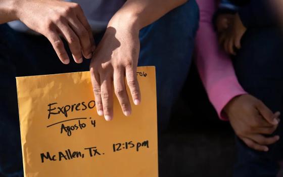 Only Ledezma's hands are shown, holding folder.