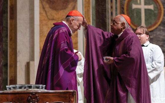 Cardinal Wilton D. Gregory, right, the retiring archbishop of Washington, dispenses ashes to Cardinal Robert W. McElroy, during Ash Wednesday Mass March 5, 2025, at the Cathedral of St. Matthew the Apostle in Washington. Cardinal McElroy will be installed March 11 as the eighth archbishop of Washington. (OSV News photo/Mihoko Owada, Catholic Standard)