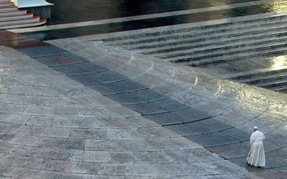 Pope prays alone in empty St. Peter's Square.