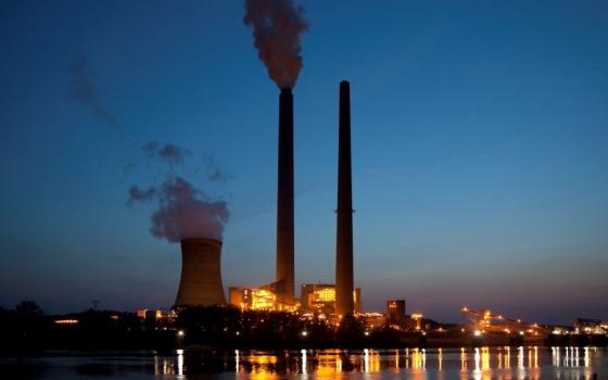 A file photo shows smoke from the American Electric Power's coal-fired Mountaineer Power Plant along the banks of the Ohio River in New Haven, W.Va. (OSV News/Jim West)