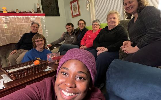 A group gathered for a prayer service at the House of Discernment is pictured in a photo. The house is located in the Millvale suburb of Pittsburgh. (Courtesy of Caryn Crook)