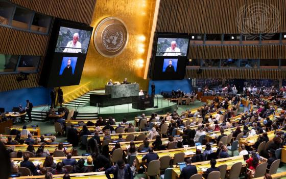 Antonio M. Lagdameo, the permanent representative of the Philippines to the United Nations and chair of the Committee on the Status of Women in 2024, pictured at the podium and upper part of screens addressing the opening of the 68th session of the CSW in March 2024.