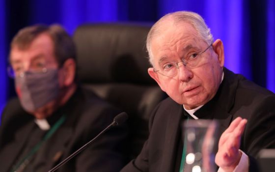 Archbishop José H. Gomez of Los Angeles, president of the U.S. Conference of Catholic Bishops, gestures during a Nov. 17, 2021, session of the bishops' fall general assembly in Baltimore. At his left is Detroit Archbishop Allen H. Vigneron. 