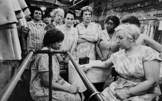 Garment workers listen to the funeral service for the Rev. Martin Luther King Jr. on a portable radio on April 8, 1968. (Flickr/Kheel Center, Cornell University)