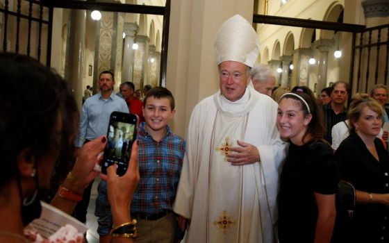 New Cardinal Robert W. McElroy of San Diego takes a photo with people after celebrating a Mass of thanksgiving at St. Patrick's Church, official home of the U.S. Catholic community in Rome, Aug. 28. (CNS/Paul Haring)