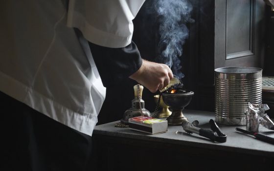 An altar server prepares a censer for use during a traditional Latin Mass July 1, at Immaculate Conception Seminary in Huntington, New York. (CNS/Gregory A. Shemitz)