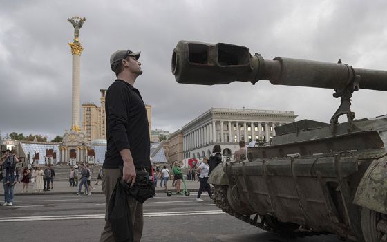 People visit an avenue where burned-out and captured Russian tanks and infantry carriers have been displayed in downtown Kyiv, Ukraine, Aug. 20. (AP/Andrew Kravchenko)