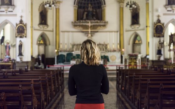 Young woman in a church (Dreamstime/Rawpixelimages)