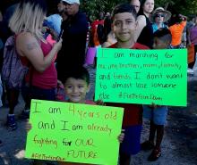 Two boys show their signs for a July 7 march against gun violence in Chicago. (Laurette Hasbrook)