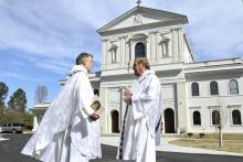 Fr. David Dye, retired administrator of Mary Our Queen Church in Peachtree Corners, Georgia, and Fr. Francis "Butch" Mazur, the last pastor of St. Gerard Church in Buffalo, New York, discuss the new Mary Our Queen Church in the background. (CNS)