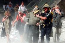 People walk away from the World Trade Center tower in New York City Sept. 11, 2001. (CNS/Reuters/Shannon Stapleton)