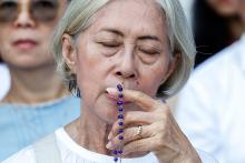 A woman prays as she awaits Mass with Pope Francis at Gelora Bung Karno Stadium in Jakarta, Indonesia, Sept. 5. (CNS/Lola Gomez)