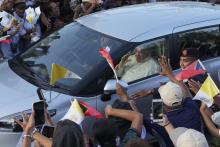 People greet Pope Francis as he travels in a car on way to the Presidential Palace in Dili, East Timor, Monday, Sept. 9, 2024. (AP Photo/Firdia Lisnawati)