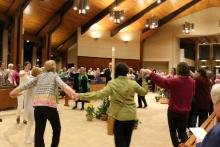 Sisters and guests dance to celebrate Easter at the Benedictine Sisters of Erie monastery in Erie, Pa.