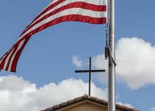 An American flag frames a cross atop Immaculate Conception Catholic Church in Cottonwood, Ariz., Oct. 29. The parish hall of the church is a polling station for voters in the Nov. 5 election. Arizona is one of seven battleground states this year. (OSV News/Bob Roller)