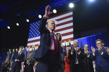 Republican presidential nominee former President Donald Trump waves as he walks with former first lady Melania Trump at an election night watch party at the Palm Beach Convention Center Nov. 6, 2024, in West Palm Beach, Fla. (AP/Evan Vucci)