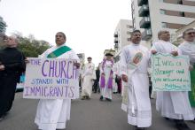 Following a prayer service for migrants in San Diego, California, participants march from the city's Catholic cathedral to the Federal Building (Chris Stone)